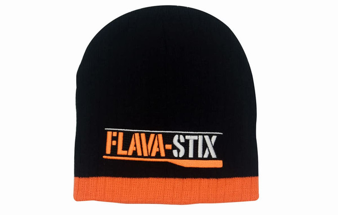 A two-tone cable knit beanie in black and orange with a logo on the front.
