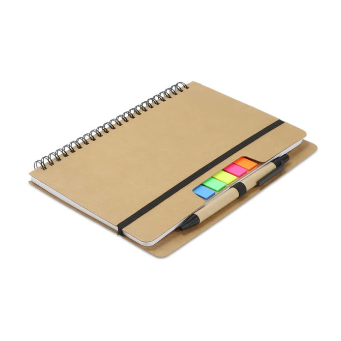 A kraft notebook with a spiral binding, featuring colourful sticky notes and a pen attached.
