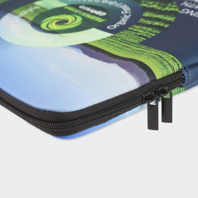 A small, full colour laptop sleeve with a blue and green design and a black zipper. Features a logo.