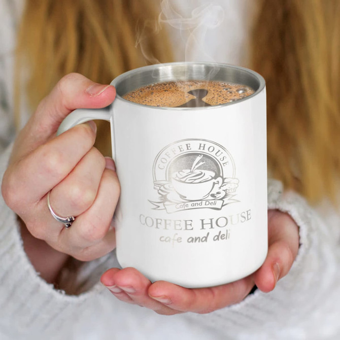 A coffee mug with a sleek design featuring a 'Coffee House' logo and a stainless steel rim, filled with steaming coffee.