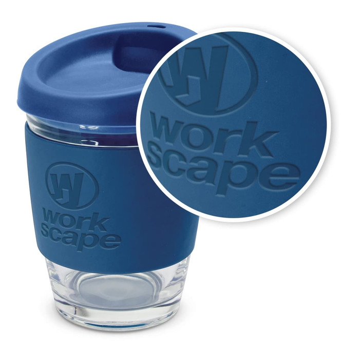 A drink bottle in blue with a silicone sleeve and lid, featuring a logo on the sleeve. The bottle is glass.
