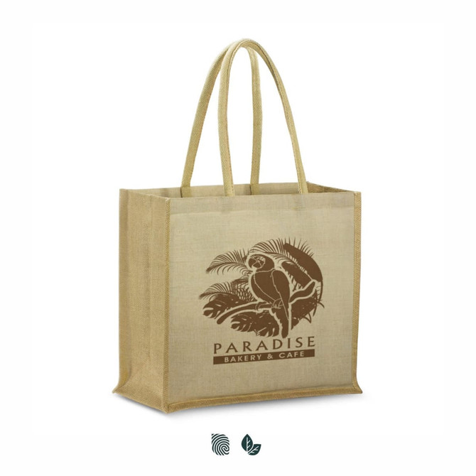 A tan juco tote bag with two sturdy handles and a logo featuring a parrot and tropical elements.