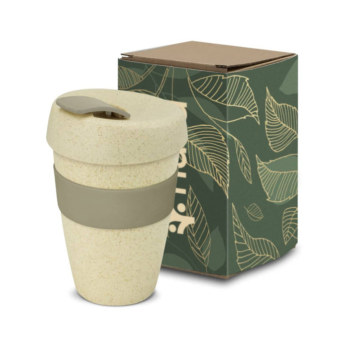 A drink bottle in a light cream colour with a green silicone band and lid, accompanied by a patterned box.