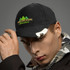 A drink bottle opener cap in black with a silver opener attachment, featuring a logo with green trees on the front.