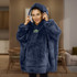 A plush navy blue hoodie with a large hood and pocket, featuring a logo on the front.