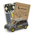 A wooden model of a hatchback car in grey, featuring a logo and accompanied by assembly parts and instructions.