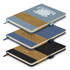 A collection of three denim notebooks in blue, black, and beige, each featuring a logo on the cover.