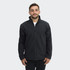 A man wearing a black soft shell jacket with a zip closure and a collar, featuring a logo on the chest.