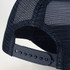 A trucker cap in navy blue featuring a mesh back and an adjustable strap for fit. It includes a logo on the front.