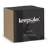 A black and beige box containing a Keepsake S'mores Kit with a logo on the front.