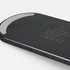 A black wireless charger with a curved design and a silver accent. It features branding on the surface.