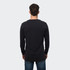 A man wearing a black long sleeve crew shirt, shown from the back, with denim jeans. The shirt features a logo.