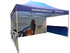A marquee tent with a blue canopy and a printed side wall featuring a logo and promotional graphics.