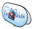 A pop-up banner featuring a red car in water, with a blue background and a logo. The banner is oval-shaped.
