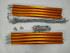An assortment of orange camping canopy poles, grey ropes, and metal hooks arranged neatly on a white background.