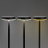 Three black rechargeable table lamps with round tops and adjustable light settings against a grey background.