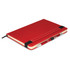 A red notebook with a pen secured on the side, featuring a black elastic band.