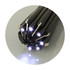 A multi-tool with black casing featuring multiple light elements and a logo. Compact and designed for various tasks.