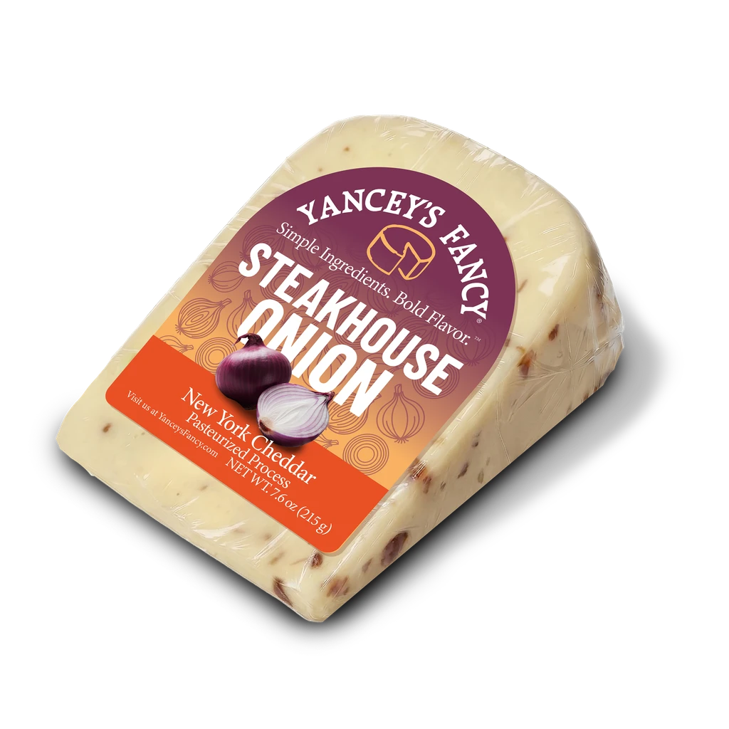 Yancey's Fancy Steakhouse Onion Cheddar cheese wedge in original packaging, front view.