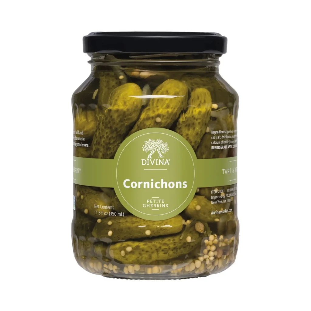 Divina petite cornichon gherkins plated out of the jar, the tangy pickle pairing in the Grand Crate gift box.