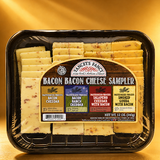 A plastic, vacuum-sealed sampler tray of Yancey's Fancy "Bacon Bacon Cheese Sampler" featuring rows of pre-sliced cheese varieties. The label has a dark wood-grain background with a large arched top. At the peak of the arch, the brand logo reads "Yancey's Fancy New York's Artisan Cheese." Below this, the product name "BACON BACON CHEESE SAMPLER" is written in a stylized, rustic white font.
The label is divided into four distinct colored blocks that detail each variety included, from left to right:
Brown block: "Bacon Cheddar" (Pasteurized Process)
Blue block: "Bacon Ranch Cheddar" (Pasteurized Process)
Red block: "Jalapeno Cheddar with Bacon" (Pasteurized Process)
Yellow block: "Smoked Gouda with Bacon" (Pasteurized Process)
The pre-sliced cheeses are arranged neatly in rows corresponding to their position on the label, transitioning from off-white varieties with bacon flecks on the left to a deeper yellow-orange smoked variety on the far right. The bottom right of the label indicates a net weight of 12 oz (340g).