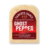 A vacuum-sealed block of Yancey's Fancy "Ghost Pepper" New York Cheddar cheese. The label is primarily deep red with a white arched border, featuring a graphic of a bright red ghost pepper in the center and faint, playful cartoon ghosts in the background. The text reads "Yancey's Fancy" in an arch at the top, followed by the tagline "Simple Ingredients. Bold Flavor." The product name "GHOST PEPPER" is written in large, bold white capital letters. The bottom of the label indicates it is a "New York Cheddar Pasteurized Process" cheese with a net weight of 7.6 oz (215 g), accompanied by small flame and sun emojis to denote heat. Flakes of red pepper are visible throughout the creamy, off-white cheese block.