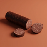 A log of Yancey's Fancy Beef & Pork Summer Sausage sliced with an orange background.