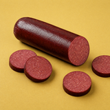 Yancey's Fancy Beef Summer Sausage sliced with a yellow background.