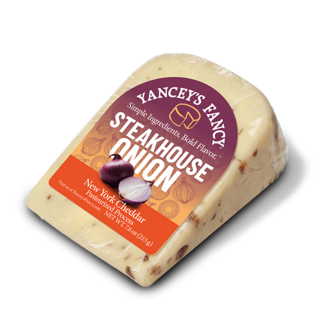 Yancey's Fancy Steakhouse Onion Cheddar cheese wedge in original packaging, front view.