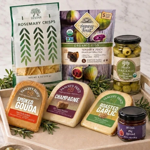 Product detail image of the Cheese Lover gift box with Yancey's Fancy smoked gouda, champagne cheddar, and roasted garlic cheddar, Divina pitted Castelvetrano olives and fig spread, rosemary crisps, and dried figs.