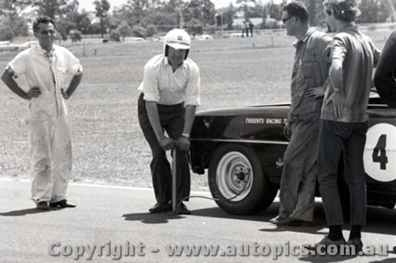 66085 - Norm Beechey Checking the tyre pressure of his Chev Nova - Warwick Farm 1966 - Photographer Lance J Ruting