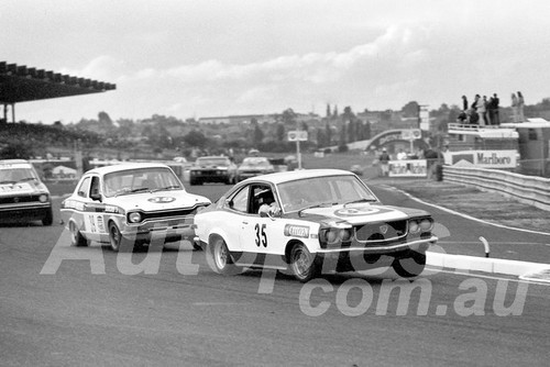 77185 - Brian Wheeler, Mazda RX3 & Ray Cutchie, Escort - Sandown - 17th April 1977 - Photographer Peter D'Abbs