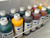 Metal rack with 12 cal-tint color bottles inside of it from an angle above