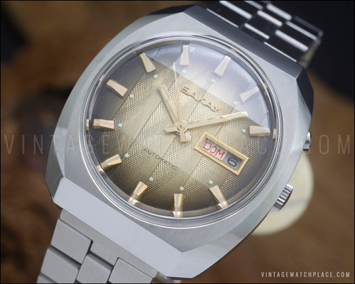 NOS Sakay 61365A automatic watch with original tags, champagne-gold textured dial, day-date calendar and faceted vintage case.