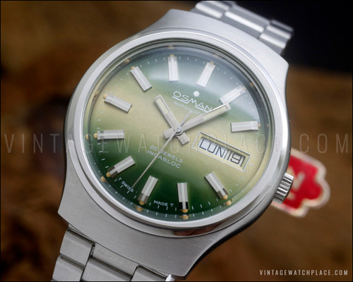 NOS Osman 2378W3 vintage automatic watch in stainless steel, with green sunburst dial, day-date calendar, original bracelet and hang tag.