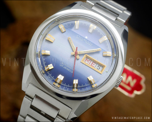 NOS Osman-Clipper LH-1004 vintage automatic watch in stainless steel, with two-tone blue dial, day-date calendar, faceted Plexiglas crystal and original steel bracelet.