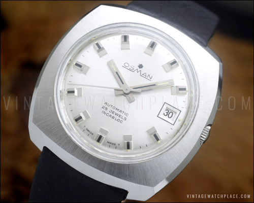 NOS Osman automatic vintage watch in stainless steel, with silver sunburst dial, raised silver-tone indexes, date window and genuine black leather strap.