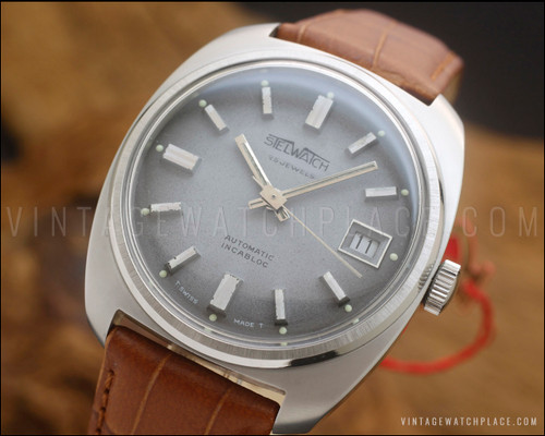 NOS Stelwatch automatic vintage watch in stainless steel, with smoky grey fumé dial, raised silver-tone indexes, date window and brown Italian leather strap.