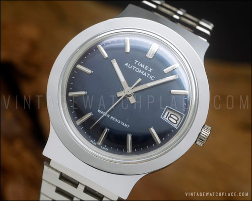 Vintage 1979 Timex Viscount automatic watch ref. 34318 10879 with blue dial, date window and stainless steel case.