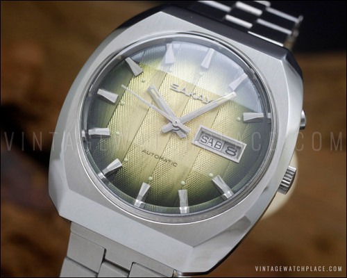 NOS Sakay 61365A automatic watch with original tags, green gradient textured dial, day-date calendar and faceted vintage case.