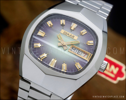 NOS Osman NS6633 vintage automatic watch in stainless steel, with purple-green gradient striped dial, day-date calendar, faceted Plexiglas crystal and original steel bracelet.