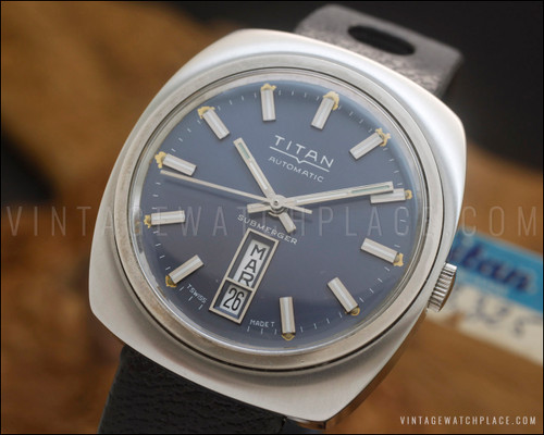 NOS Titan Submerger 1090 automatic vintage watch in stainless steel, with blue-grey dial, aged luminous dots, Spanish day-date calendar and black perforated strap.