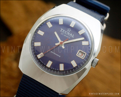 NOS Tecnal automatic vintage watch with deep blue dial, 30-jewel marking, red central seconds hand, angular 1970s case and blue NATO-style fabric strap.