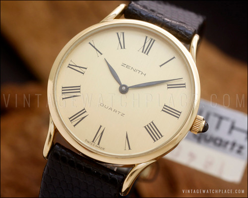 
Zenith vintage Swiss quartz watch, New Old Stock Time Capsule, with 18K gold-plated case, champagne Roman numeral dial and original black Zenith leather strap.
