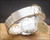 Sakay signed bracelet clasp with original hang tag, showing the New Old Stock presentation and steel bracelet condition.