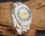 Front display of the Sakay 61365A automatic watch, showing the full steel bracelet, green-to-gold dial layout and day-date calendar.