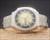 Front view of the vintage Sakay automatic watch, with green-to-gold textured dial, applied hour markers, luminous dots and day-date display.