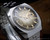 Angled view of the New Old Stock Sakay 61365A automatic, showing the champagne-gold textured dial, smoky outer edge, day-date window and crown-side case profile.