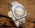 Vintage Sakay NOS automatic watch with original tag, faceted case, champagne-gold dial and steel bracelet presentation.