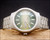 Front view of the Osman 2378W3 automatic watch, with green gradient dial, applied hour markers, luminous dots and framed day-date display.